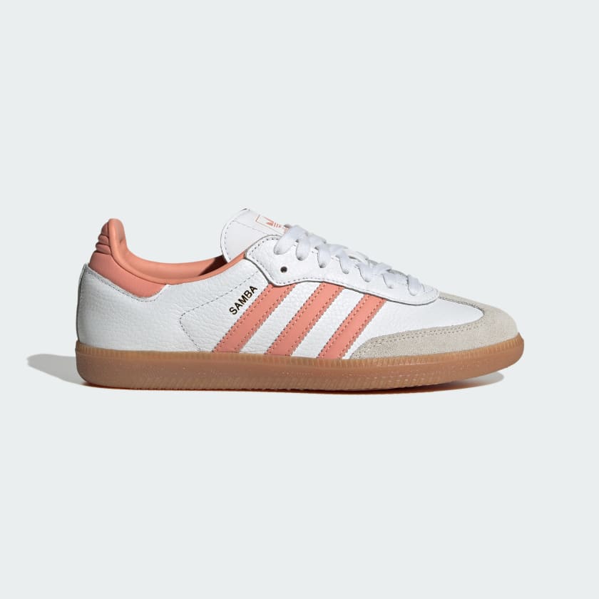 Adidas Samba OG sneakers in white and pink with leather and suede materials, featuring the brand's logo on the tongue and insole.