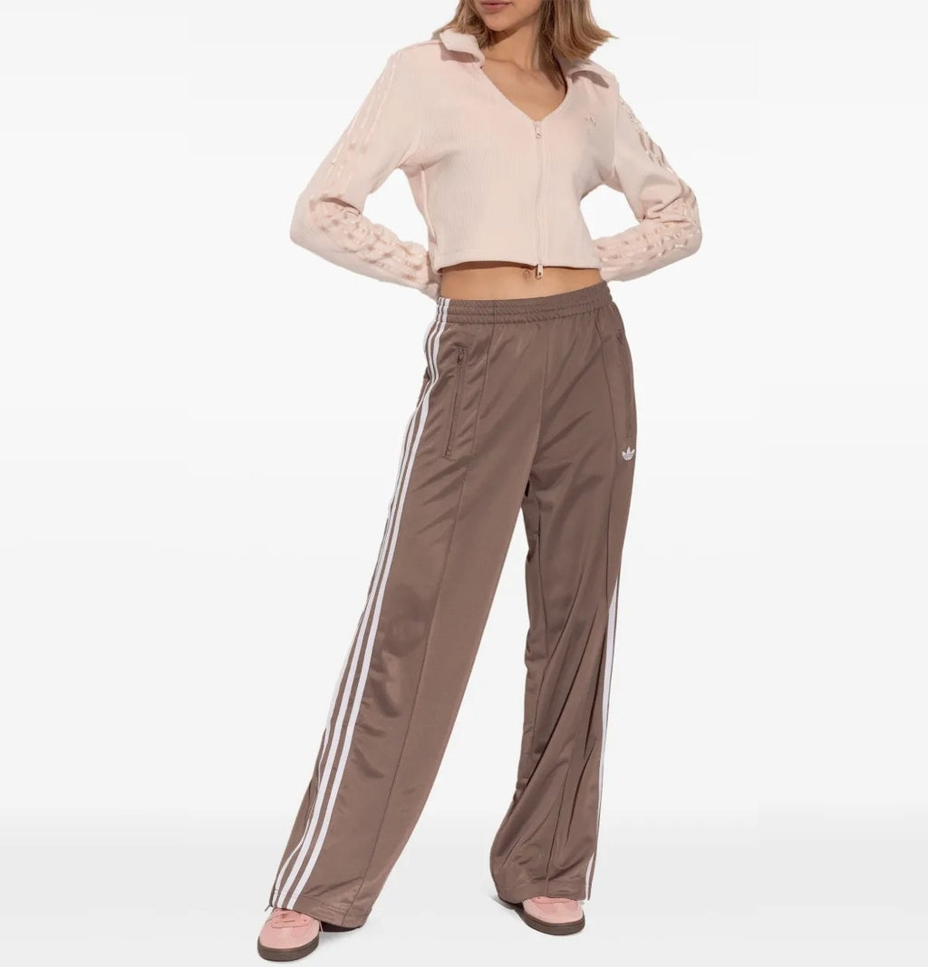 All About Pink Adidas sneaker with three white stripes