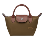 Brown handbag with leather handles and accents on a light gray background
